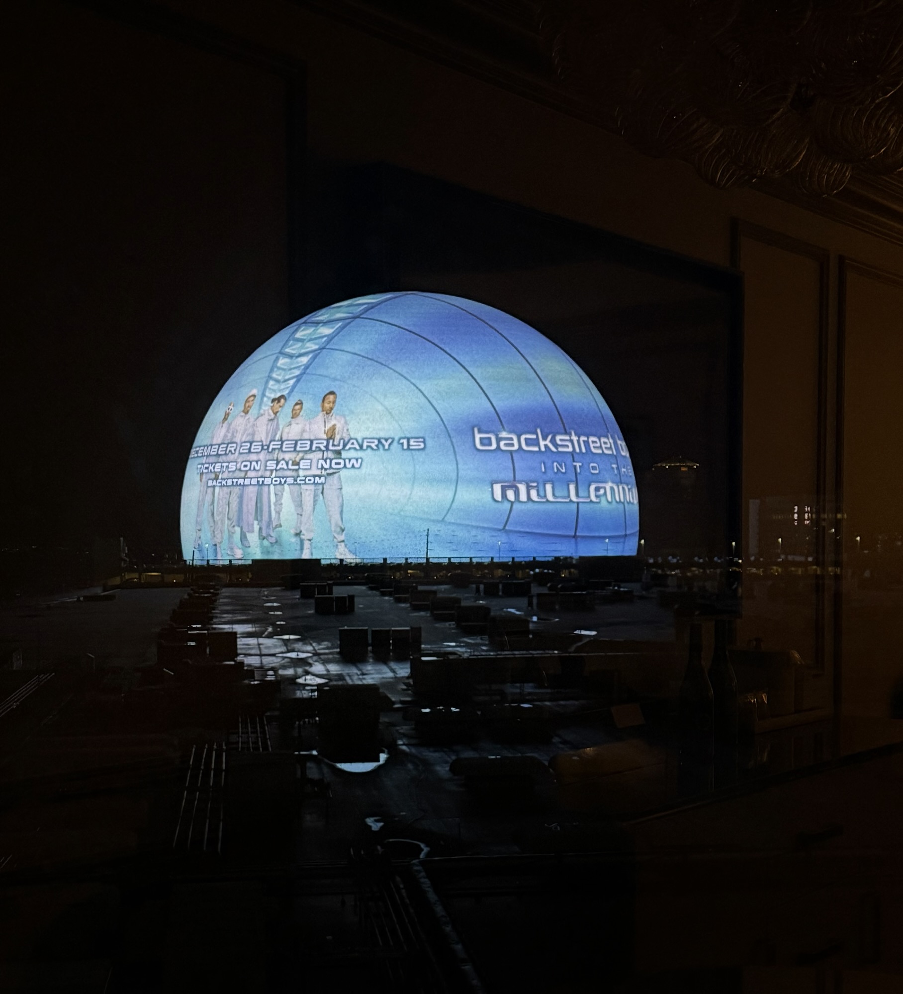 The Sphere in Las Vegas glowing with blue and colorful lights at night during the Backstreet Boys concert.